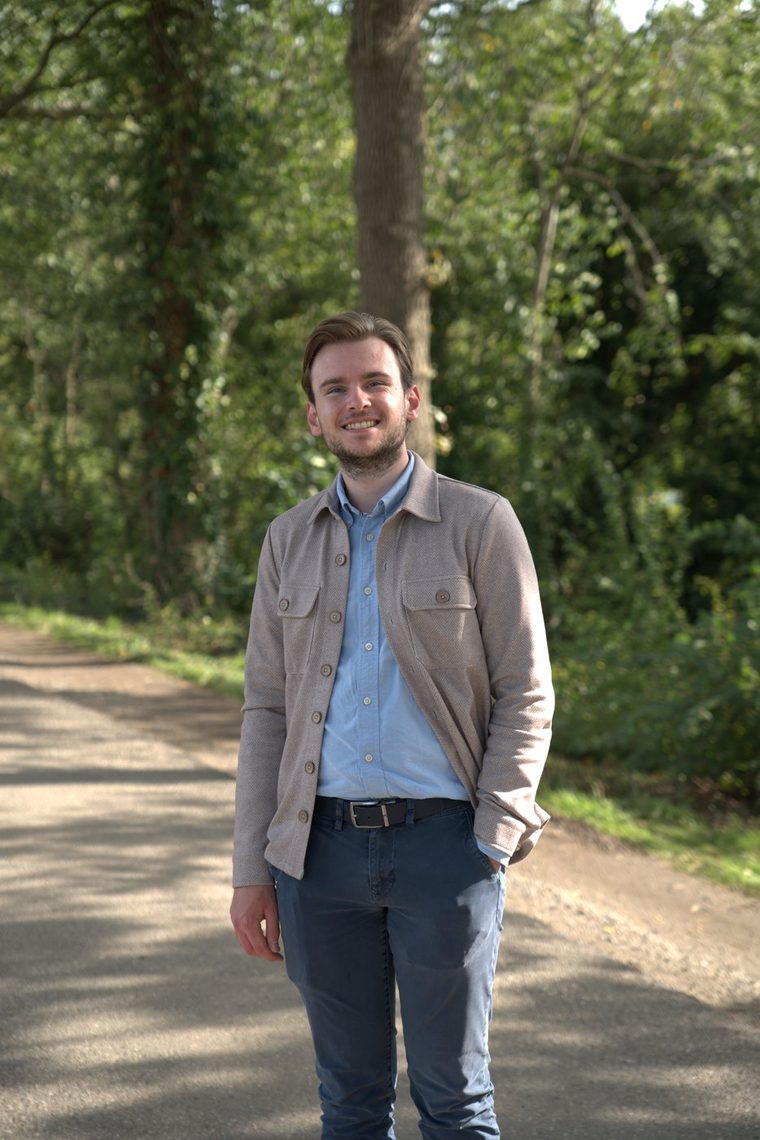 Ralph J. Smit standing on a tree-lined path